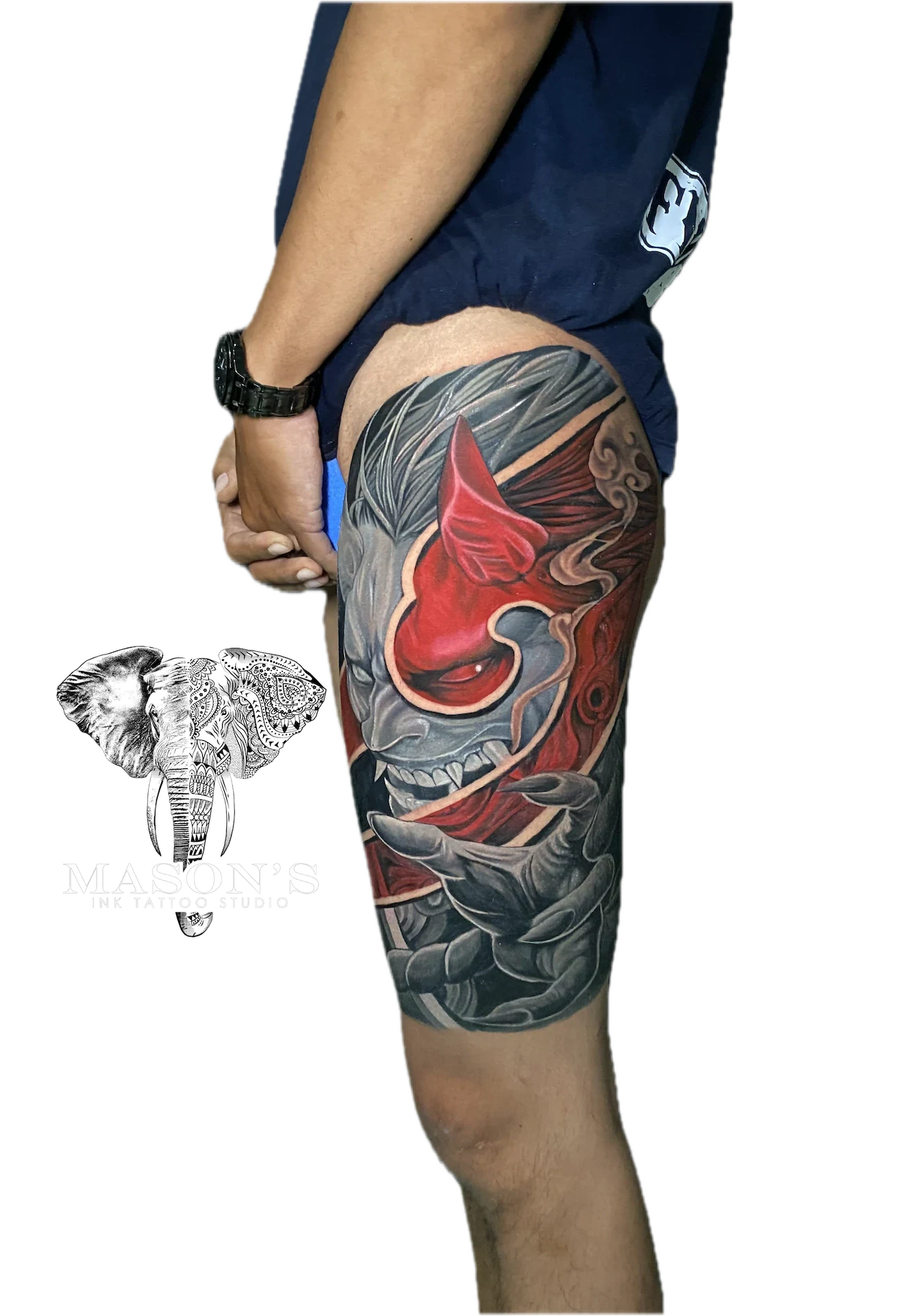 Colored Japanese Tattoo Design: a large thigh tattoo of a red and grey mythological mask with waves