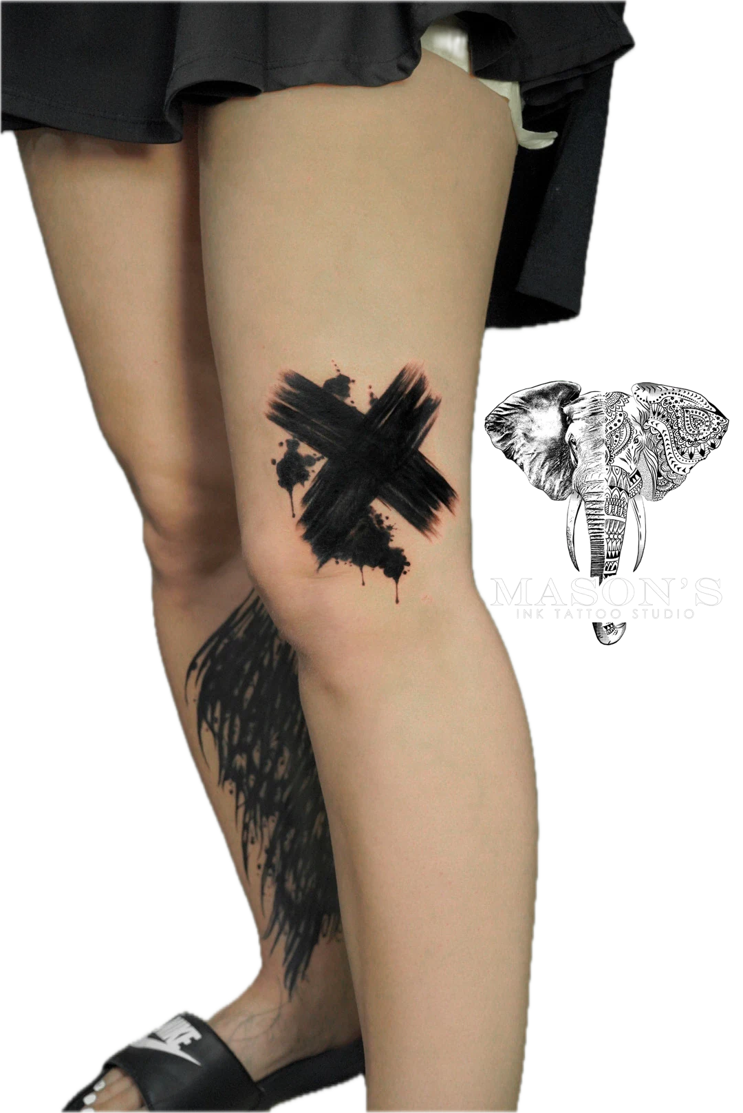 Black Work Abstract X Tattoo Design: a minimalist black and grey thigh tattoo with an X and splatter design
