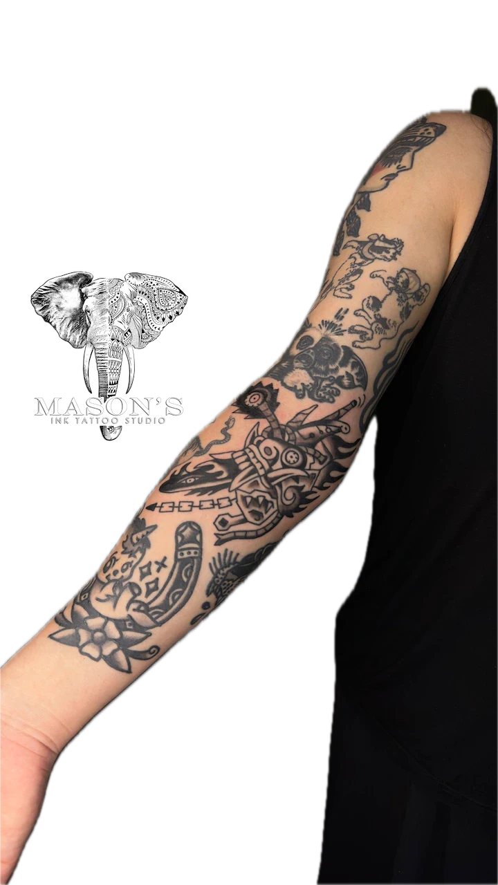 Black and Grey Traditional Patchwork Sleeve Tattoo Design - American Traditional tattoo by Mason's Ink Tattoo Studio, Bali