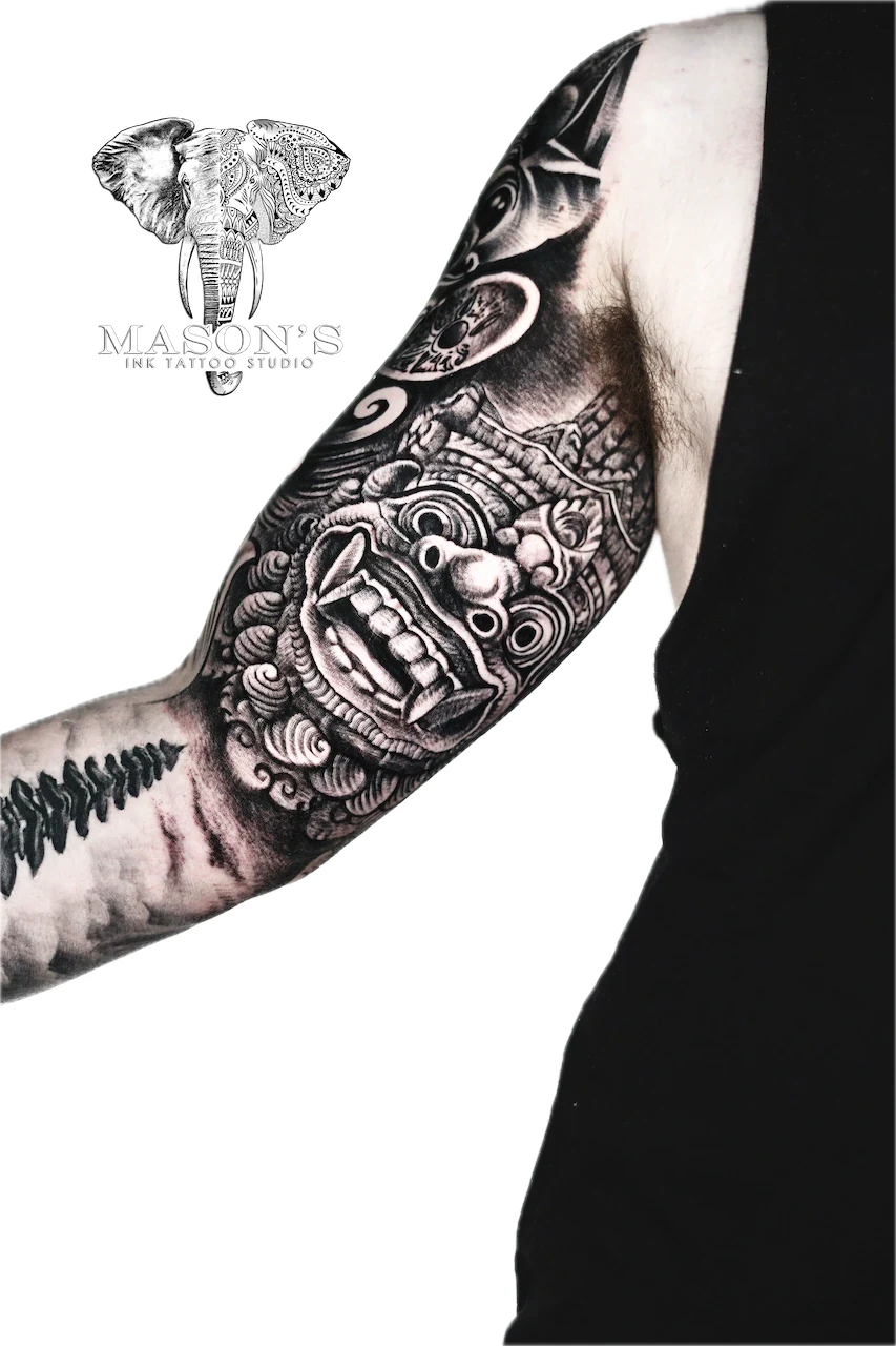 Traditional Barong Tattoo Design: a large forearm tattoo of a detailed mythological mask with intricate patterns