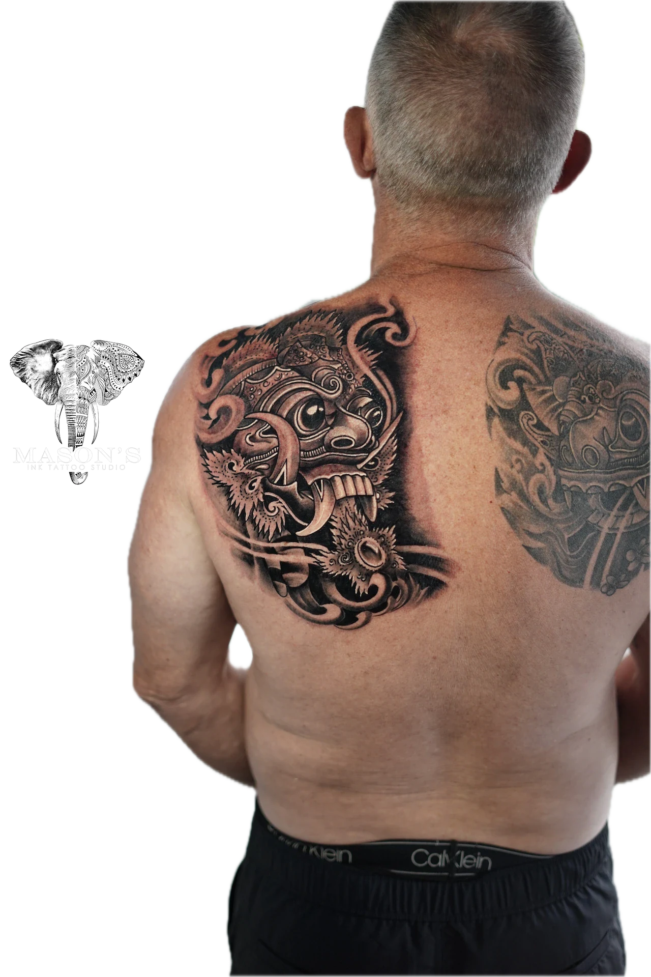 Balinese Barong Tattoo Design: Intricate dragon mask and ornamental designs on the back