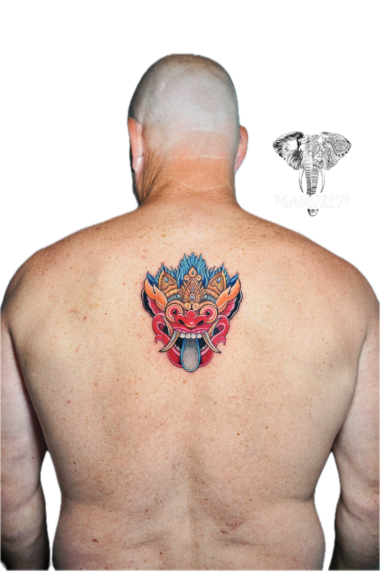 Colored Barong Tattoo Design: a colorful mythological mask with flames and horns on the back
