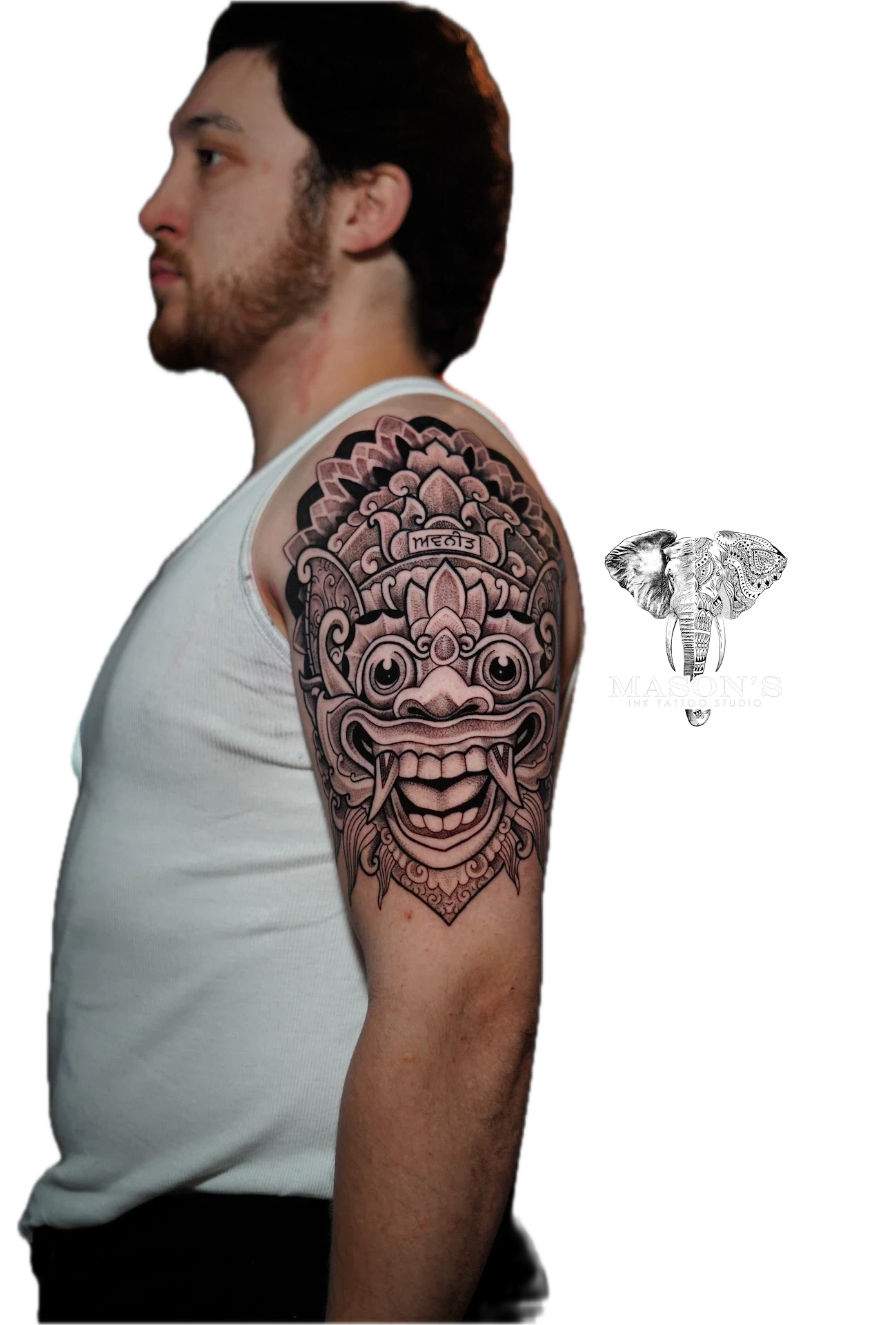 Balinese Barong Tattoo Design: a large intricate balinese mask tattoo on the upper arm
