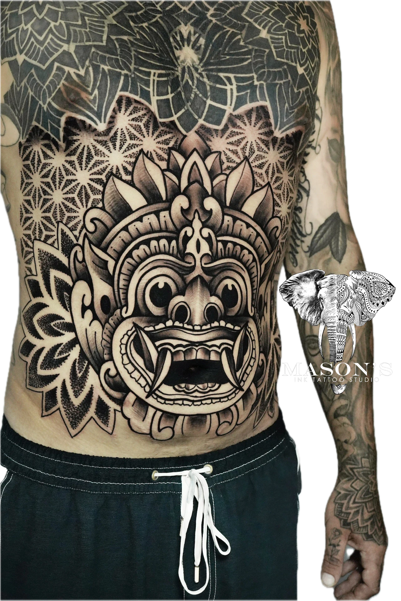 Balinese Barong Tattoo Design: a large black and grey mask with geometric patterns on the back