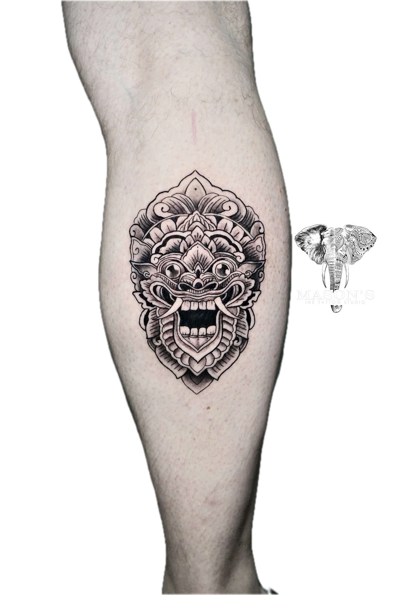 Balinese Barong Tattoo Design: a detailed mandala mask tattoo on the calf