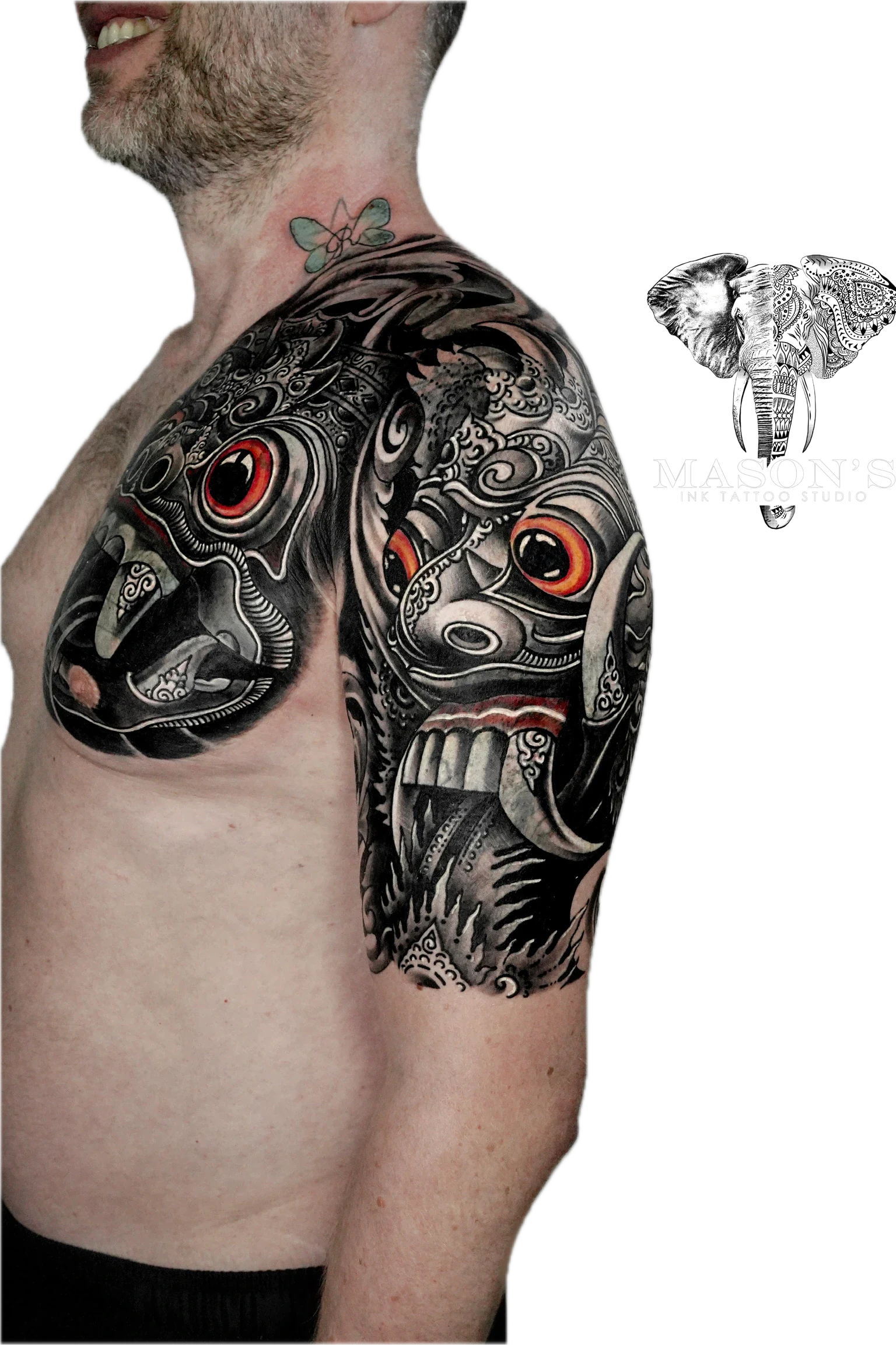 Balinese Barong Tattoo Design: Intricate mask and face design with ornate patterns on upper arm