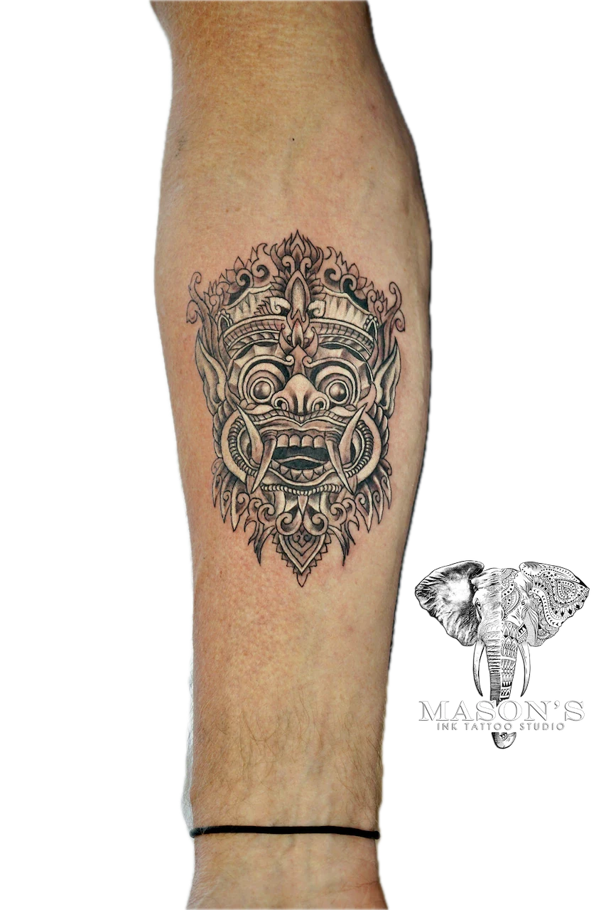 Traditional Barong Tattoo Design: a detailed ornamental mask design on a calf