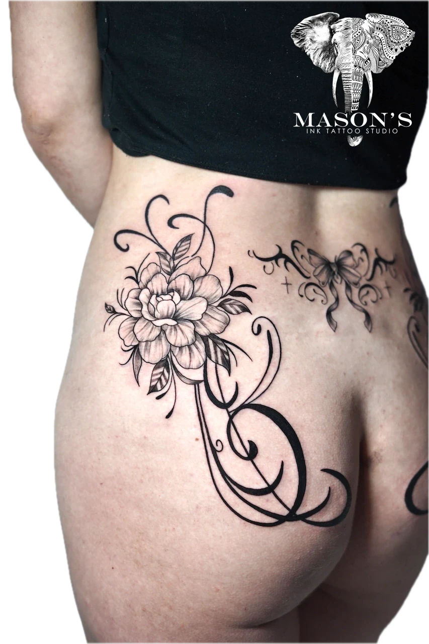 Black and Grey Floral Fine Line Tattoo Design: a detailed flower with butterfly and vines on the hip