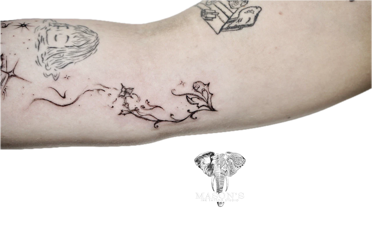 Black and Grey Tattoo Design: Minimalist forearm tattoo of a portrait with stars and ivy