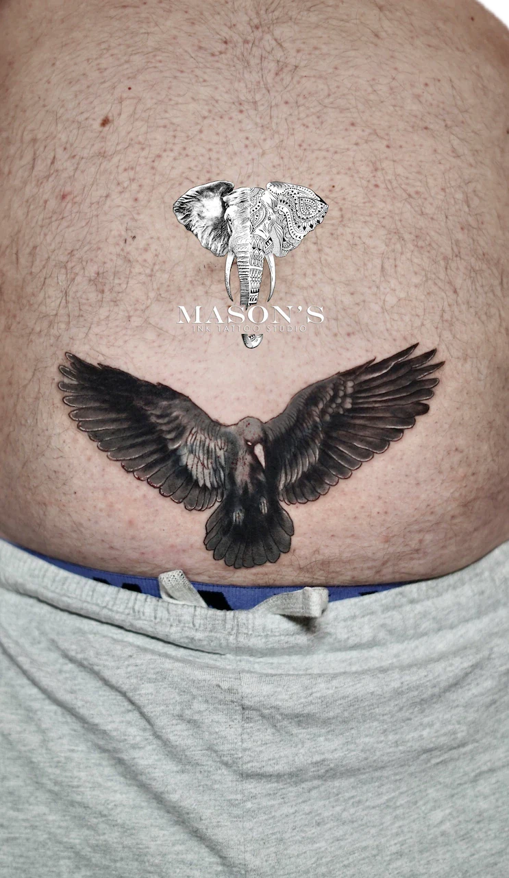 Black and Grey Eagle Tattoo Design: an elephant and dove tattoo with lettering on the stomach