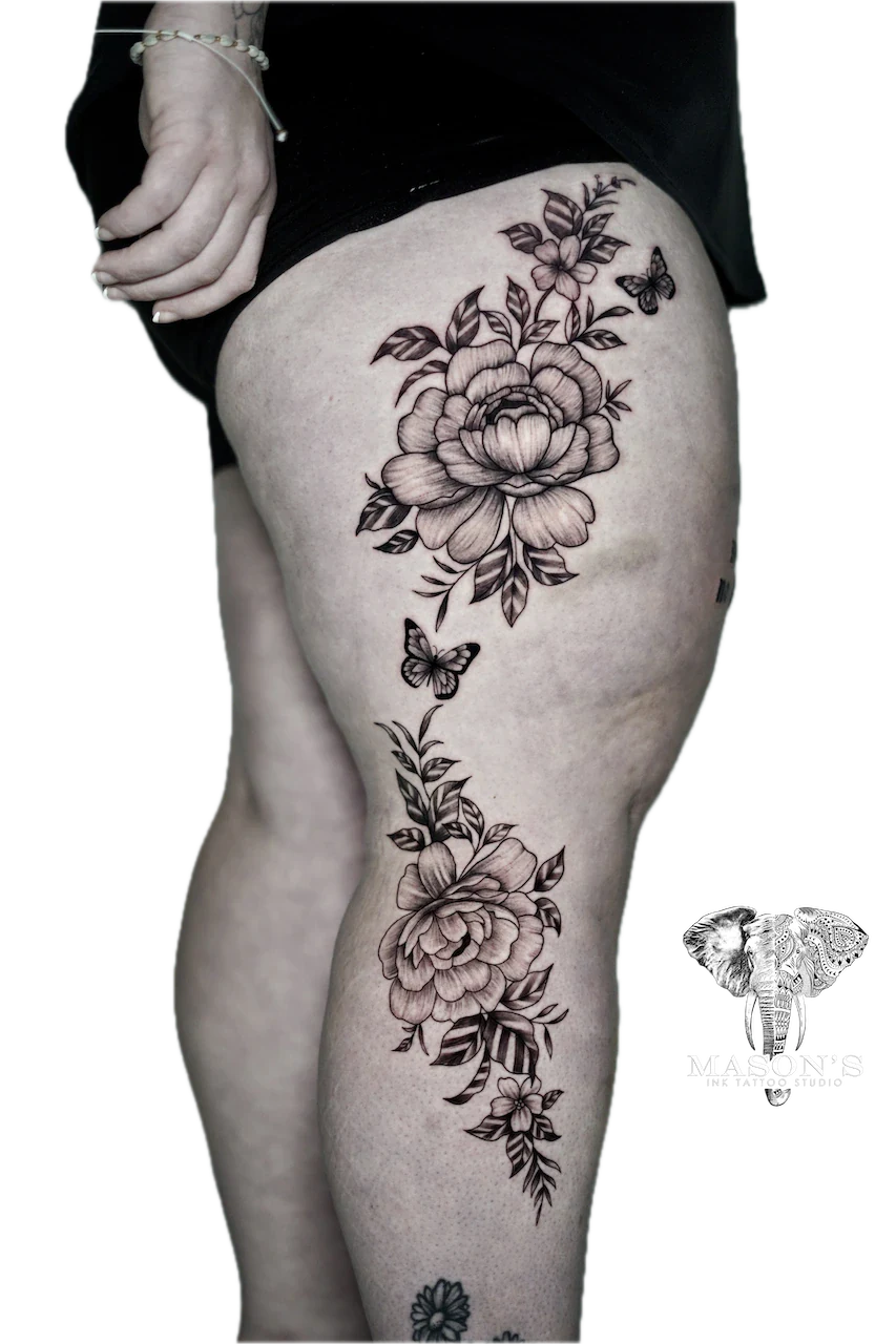 Black and Grey Flower Tattoo Design: Large floral tattoo with butterflies on the thigh