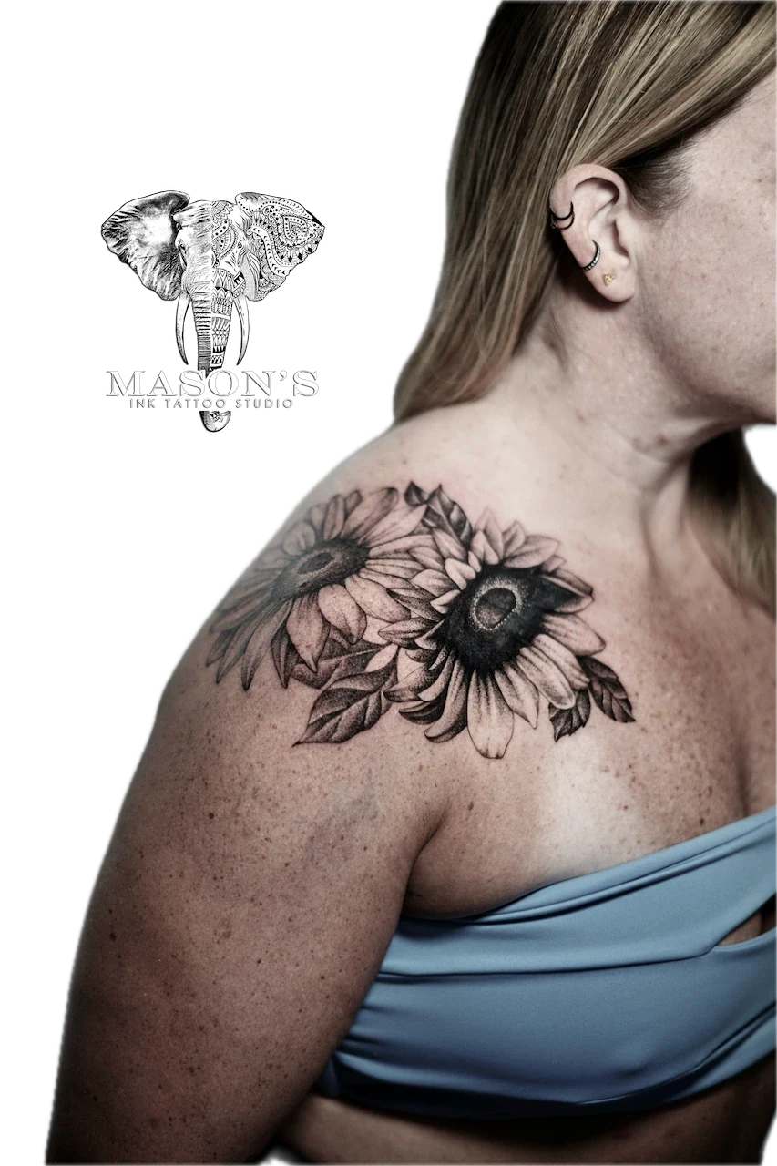 Black and Grey Flower Tattoo Design: Two sunflowers with detailed petals and leaves on the shoulder