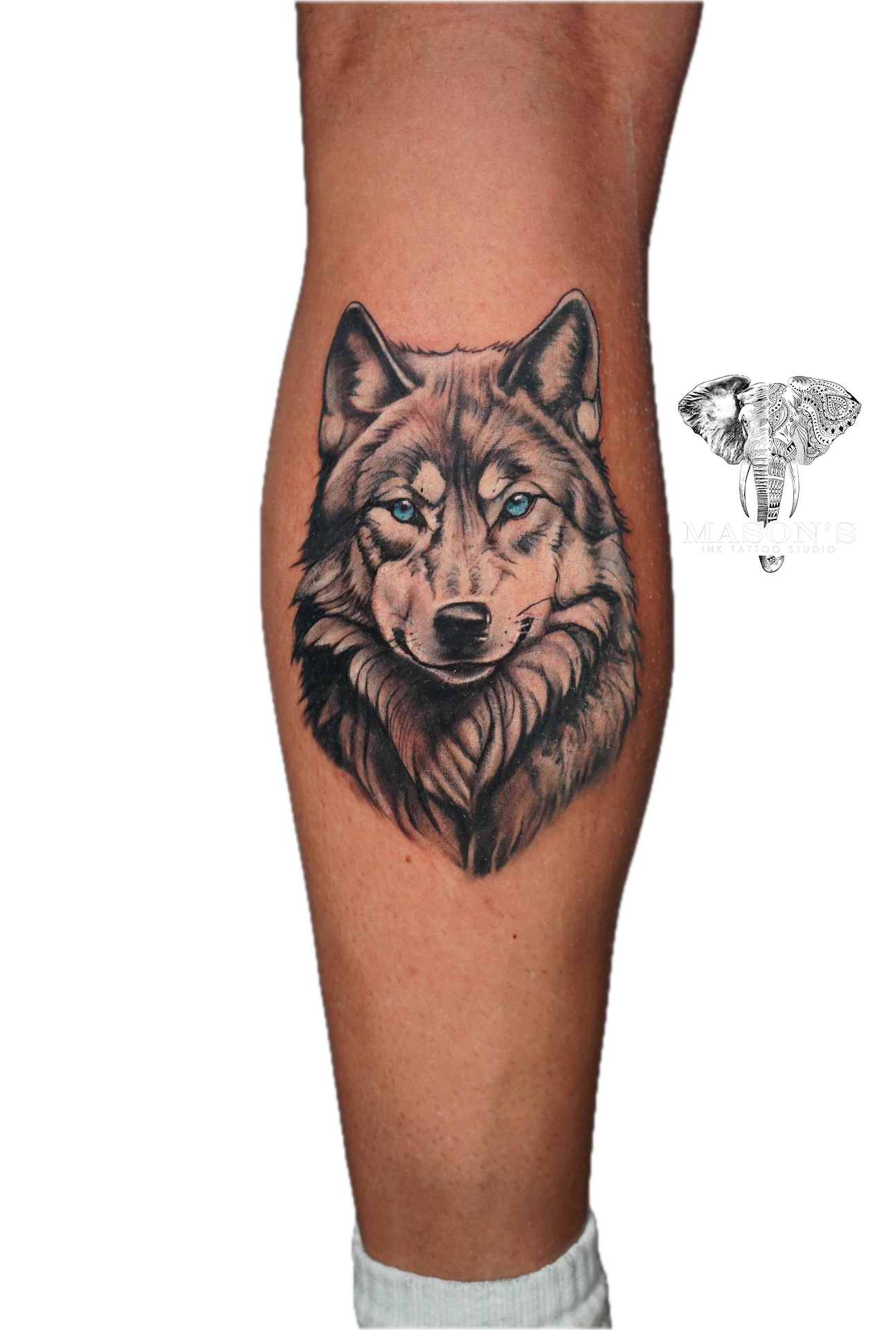 Black and Grey Realism Wolf Tattoo Design: a detailed wolf portrait on the calf