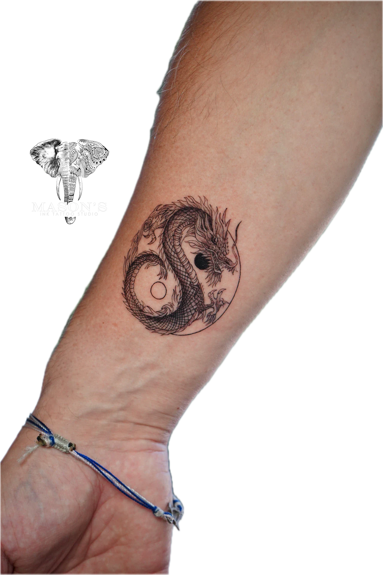 Black and Grey Dragon Tattoo Design: a stylized dragon encircling an eye on the forearm
