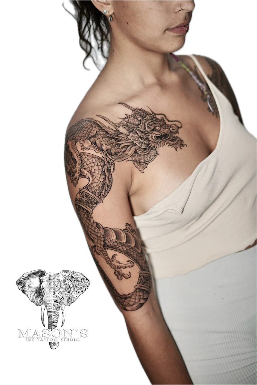 Black and Grey Dragon Tattoo Design: a detailed dragon tattoo covering the upper arm
