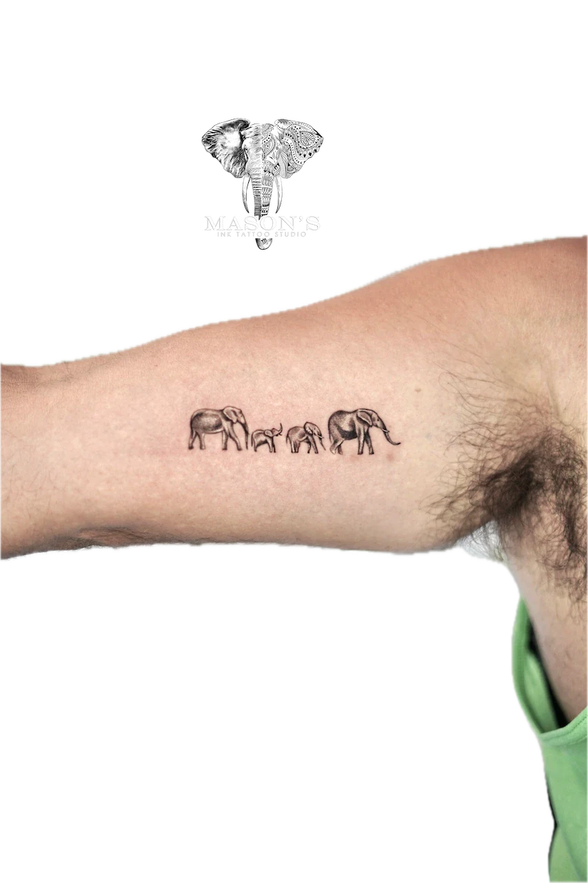 Black and Grey Elephant Tattoo Design: a minimalist tattoo of elephants and a giraffe in a natural scene