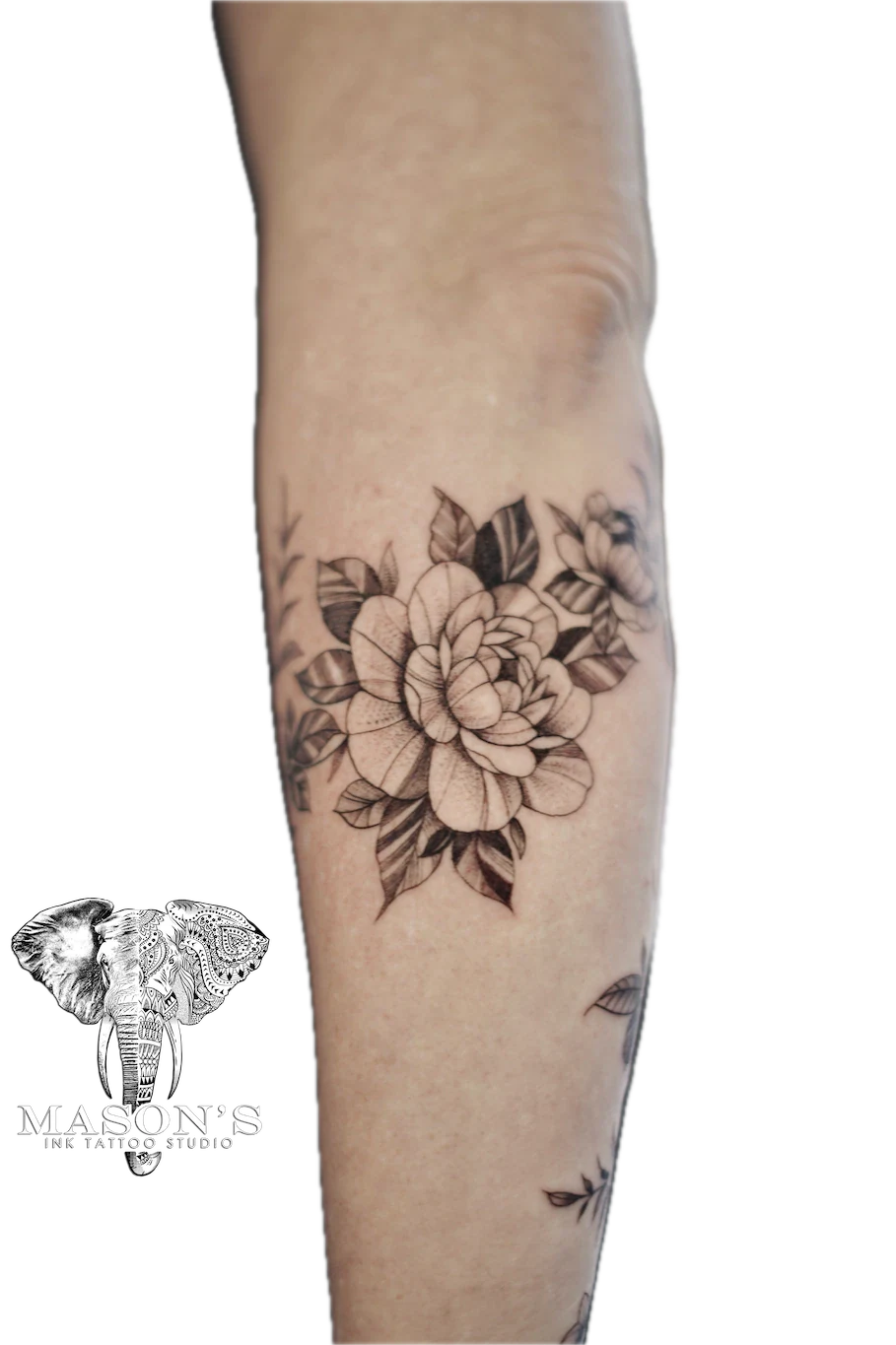 Black and Grey Floral Arm Tattoo Design: a detailed black and grey flower tattoo on the calf