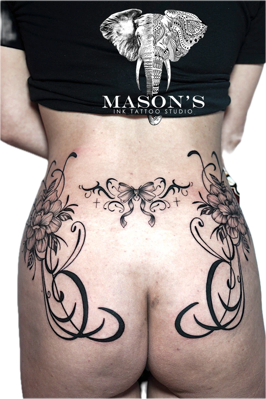 Black and Grey Floral Tattoo Design: Intricate floral and butterfly tattoo on the hip