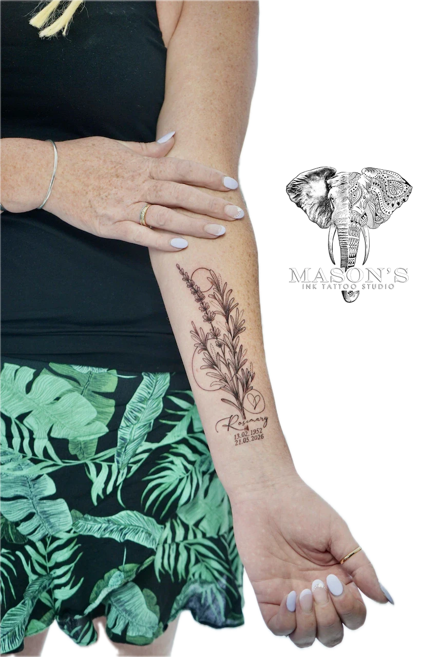 Black and Grey Floral Script Tattoo Design: a rosemary plant with dates and a heart on a forearm