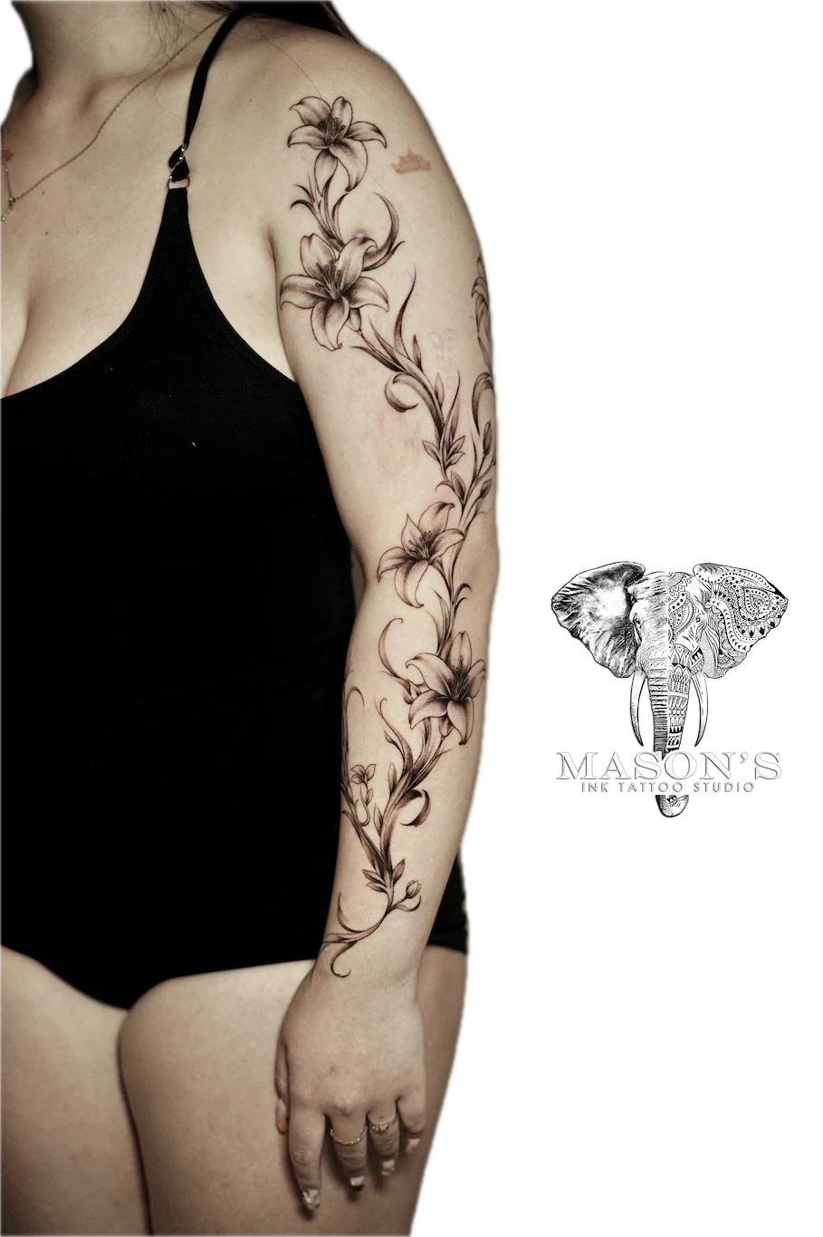 Black and Grey Floral Tattoo Design: a detailed black and grey floral sleeve tattoo with flowers and vines