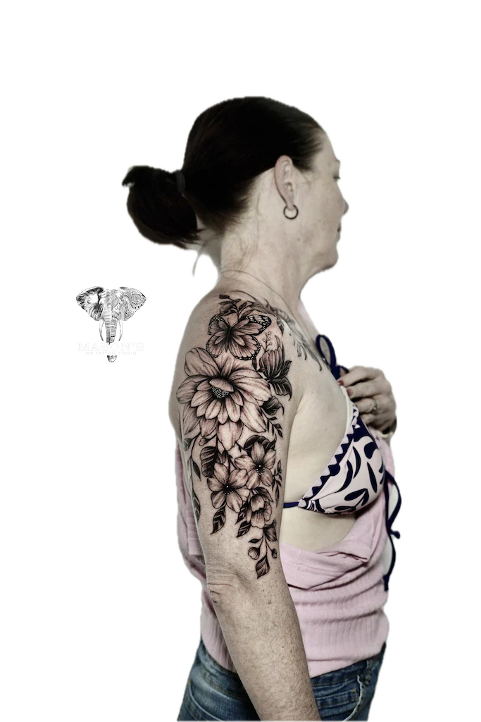 Black and Grey Floral Tattoo Design: a large black and grey floral tattoo on the upper arm