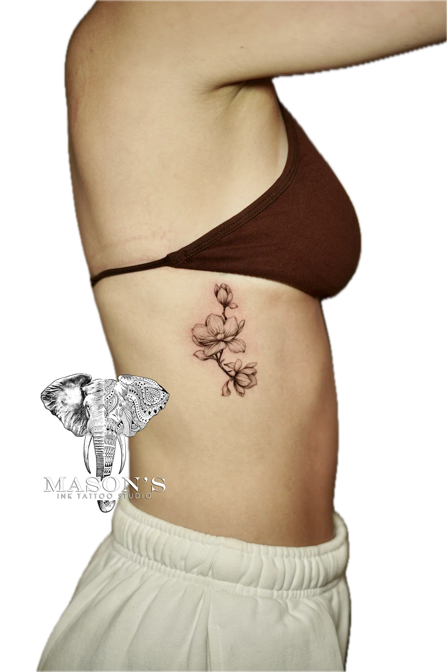Black and Grey Floral Tattoo Design: a delicate flower branch tattoo on the hip