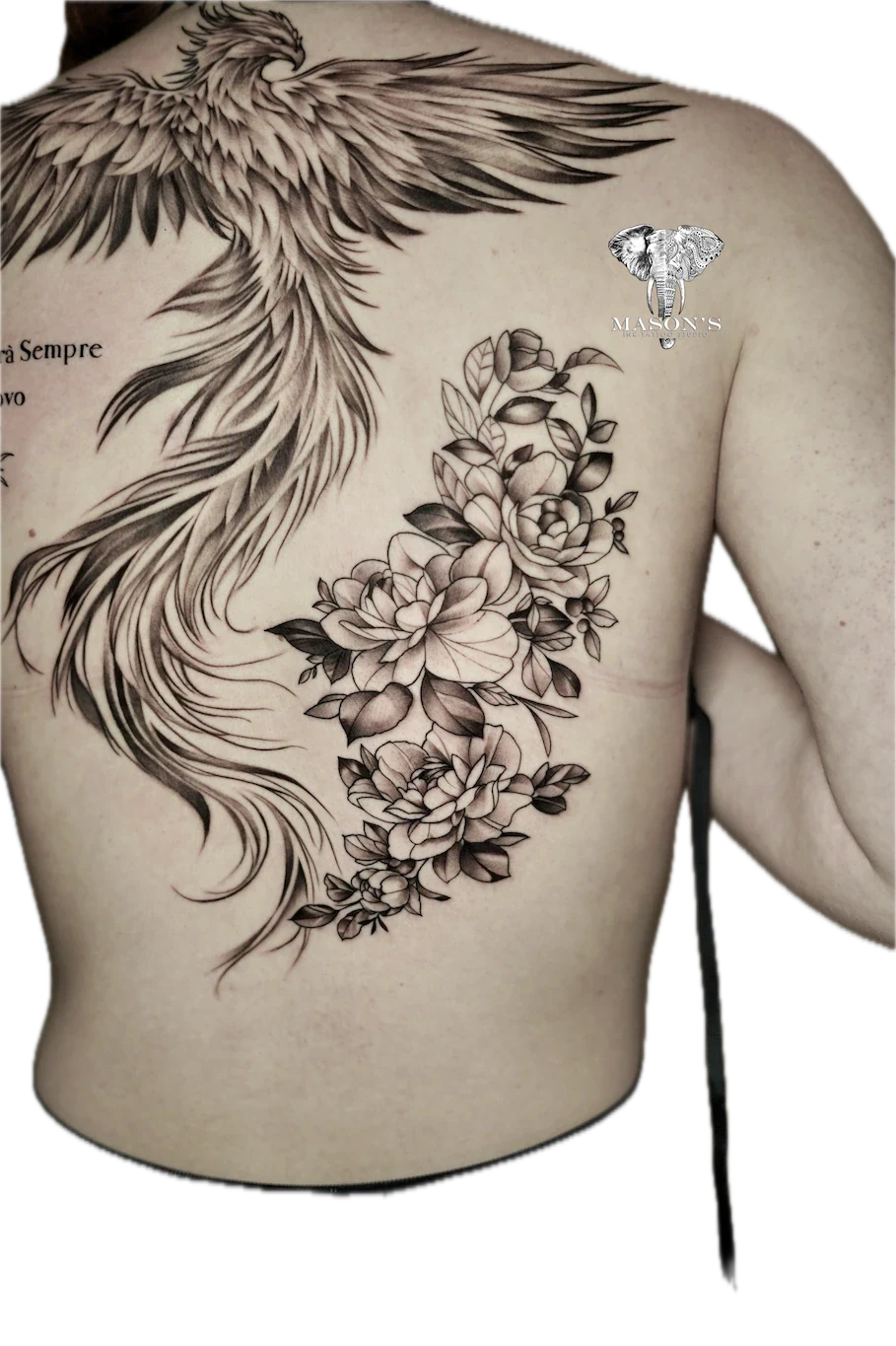 Black and Grey Floral Tattoo Design: Large back tattoo of a phoenix, flowers, and an elephant