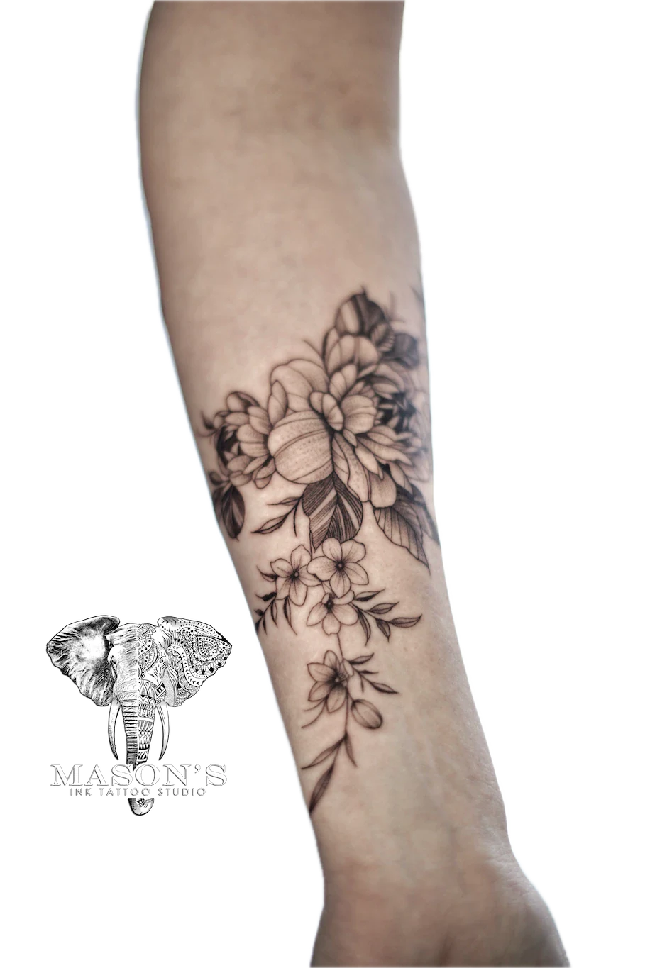 Black and Grey Flower Arm Tattoo Design: a delicate floral design on the forearm
