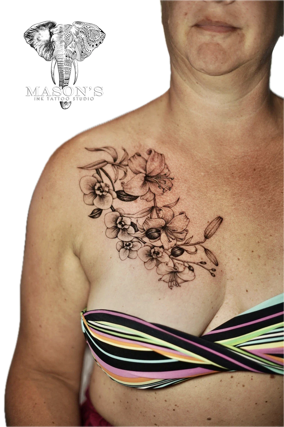 Black and Grey Flower Tattoo Design: a detailed black and grey floral tattoo on the chest