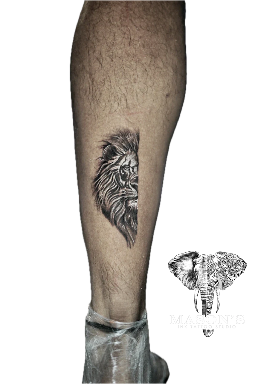 Black and Grey Half Face Lion Tattoo Design by Mason's Ink Tattoo Studio, Bali