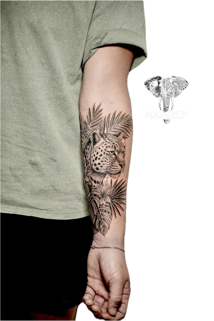 Black and Grey Leopard Cover Up Tattoo Design: a detailed leopard head with palm leaves on a forearm