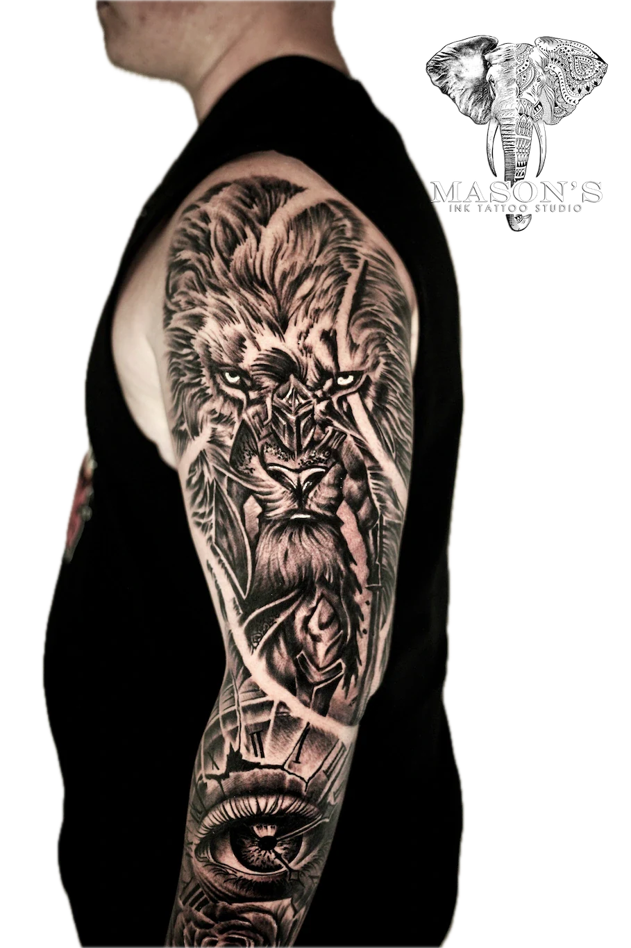 Black and Grey Lion Tattoo Design: a detailed lion portrait with vines and a skull on a full sleeve
