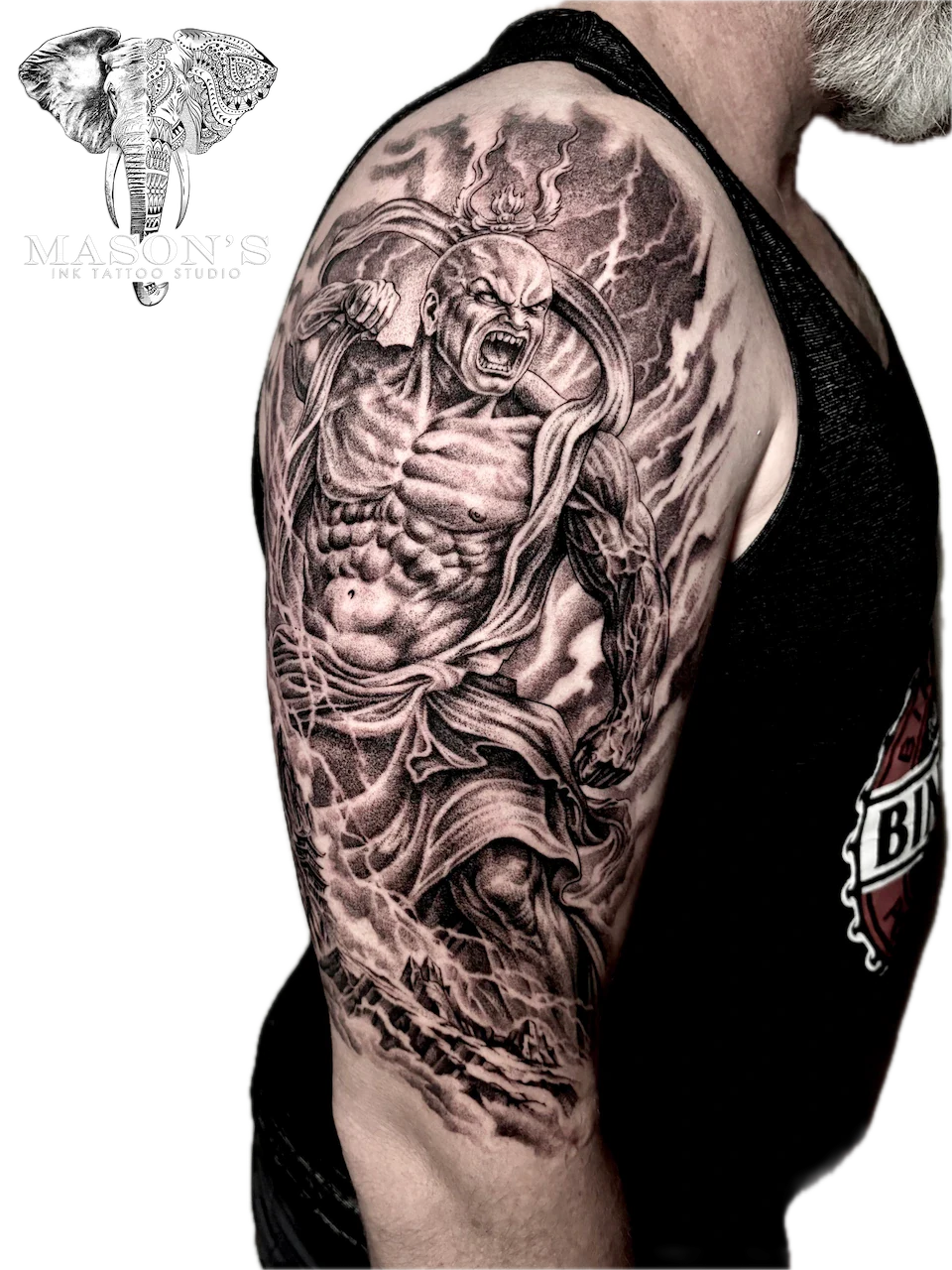 Black and Grey Monk Warrior Tattoo by Mason’s Ink: a detailed black and grey portrait of a muscular man with smoke