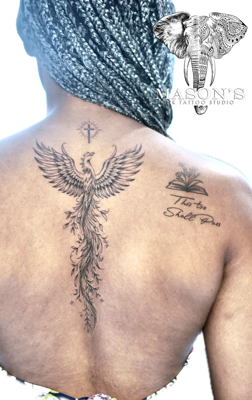 Black and Grey Phoenix Tattoo Design: a large phoenix with flames and a cross on the back