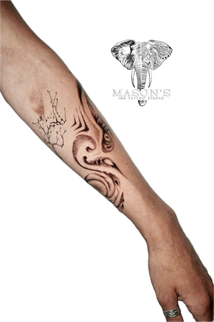 Black and Grey Smoke Tattoo Design: a large forearm tattoo of a tree, wave, and mandala design