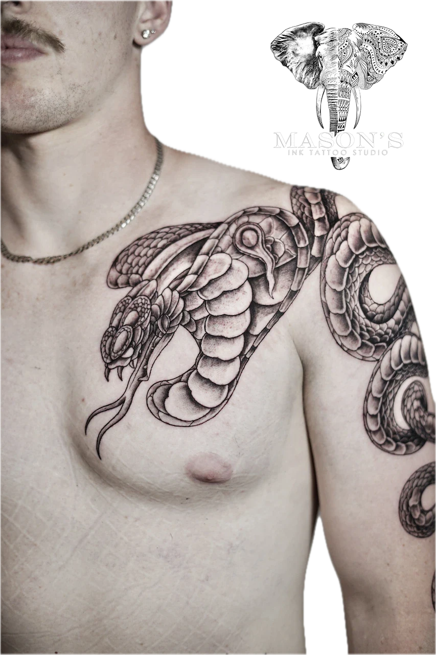 Black and Grey Snake Tattoo by Mason’s Ink: a detailed snake with intricate shell and eye patterns on the chest