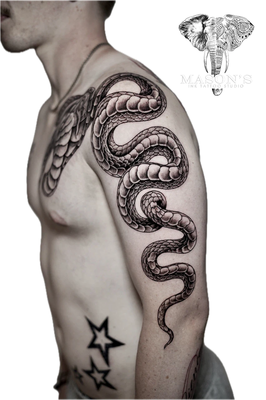 Black and Grey Snake Tattoo by Mason’s Ink: a detailed snake with wings wrapped around an upper arm