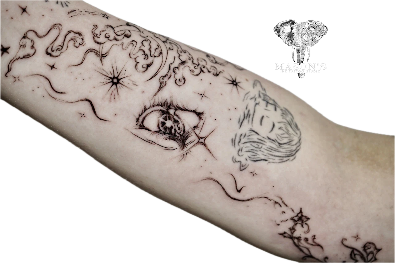 Black and Grey Tattoo Design: a detailed forearm tattoo featuring an eye, portrait, and celestial elements