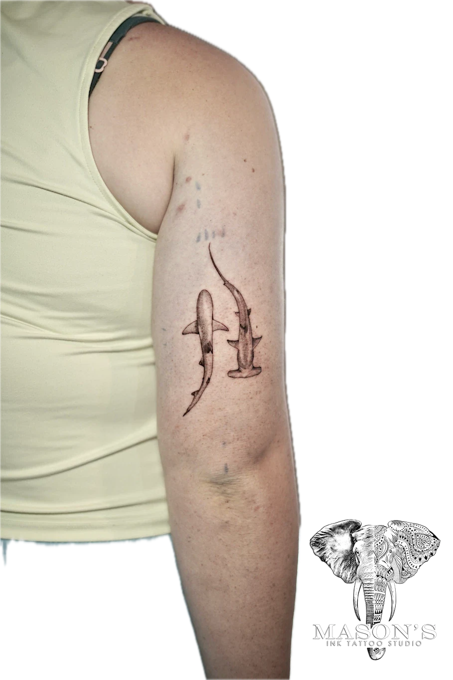 Black and Grey Tattoo Design: Three small sharks swimming in a line on the forearm