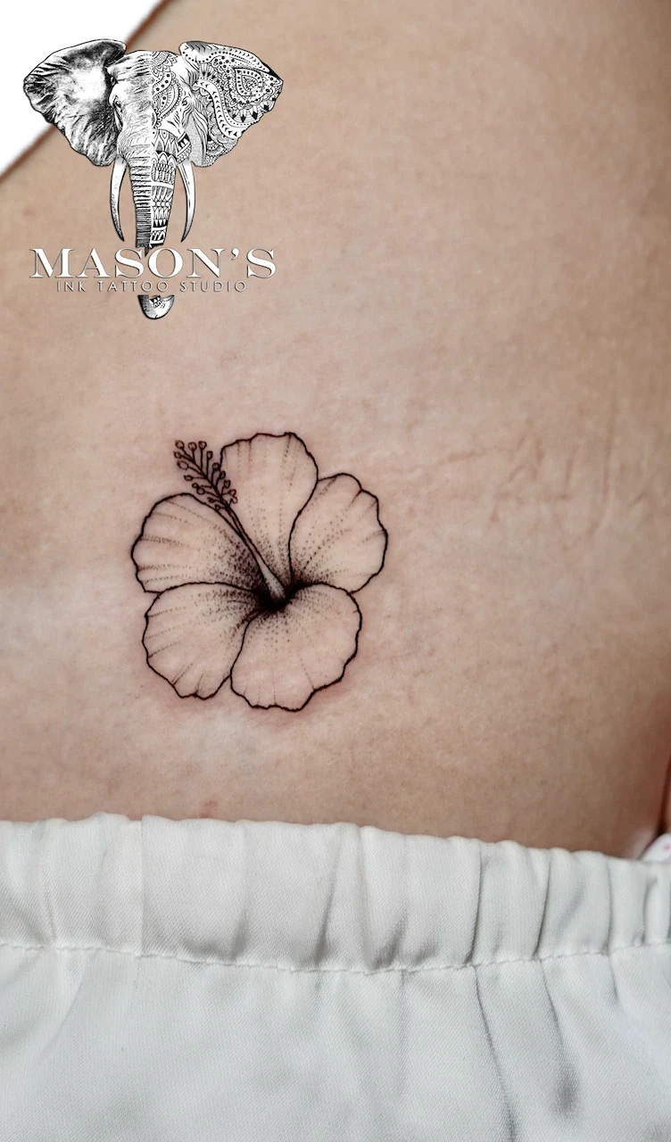 Black and Grey Woman Floral Butterfly Tattoo Design: a small hibiscus flower tattoo on the stomach