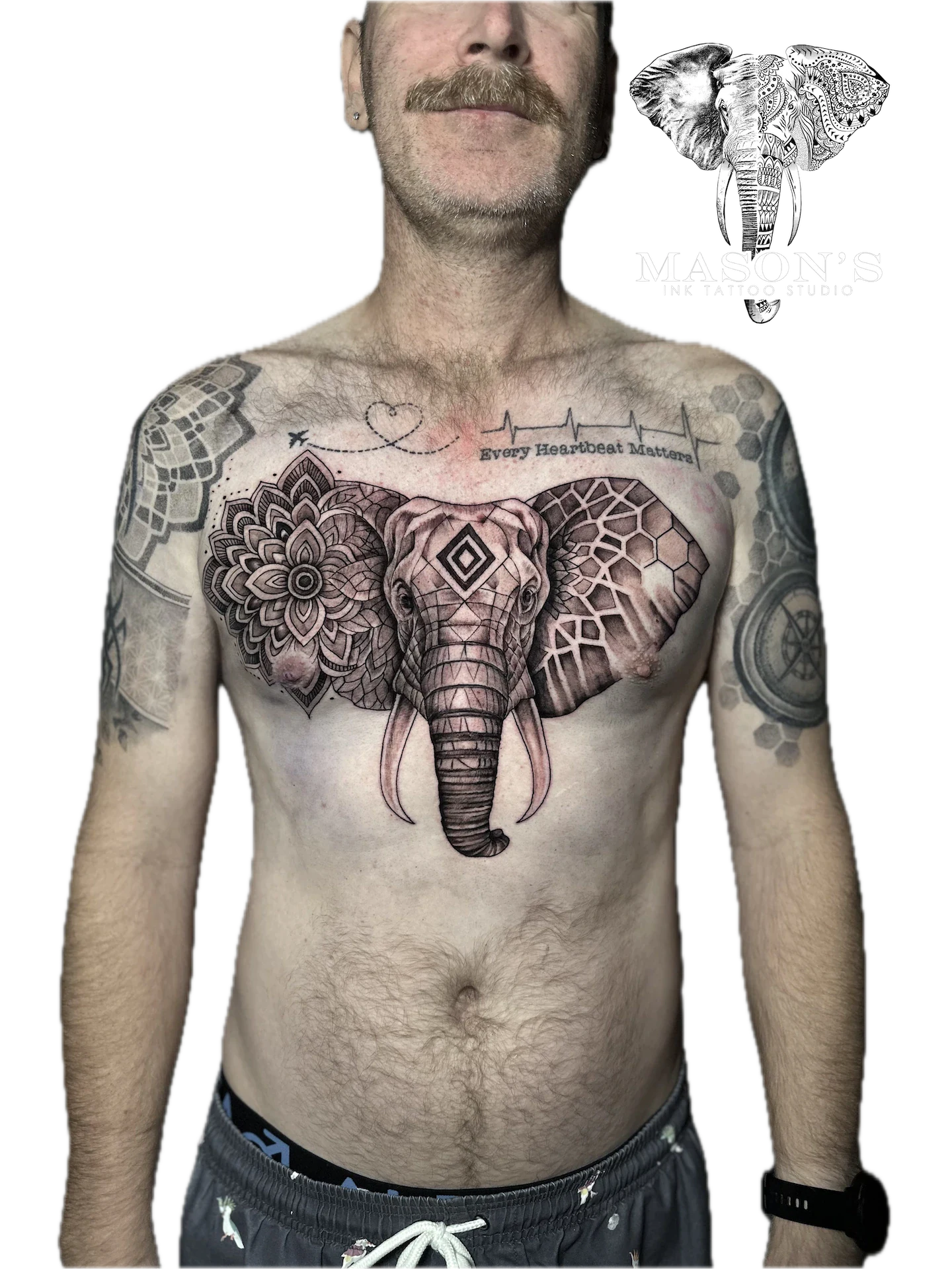 Black and Grey Elephant Tattoo Design: an elephant inside a heart with mandala and geometric patterns on the chest