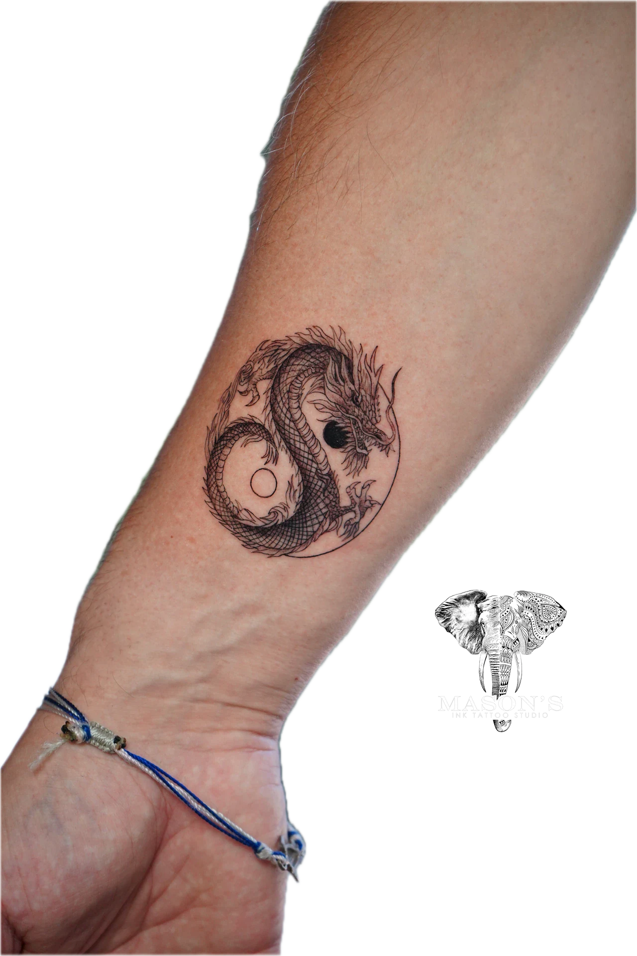 Black and Grey Dragon Tattoo Design: a black and grey dragon yin yang symbol on the forearm