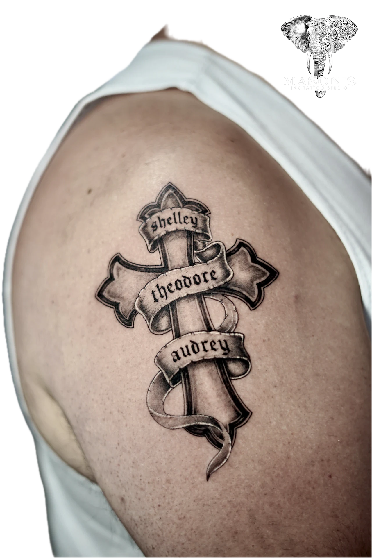 Black and Grey Realism Cross Tattoo Design: a cross with names on ribbons in black and grey