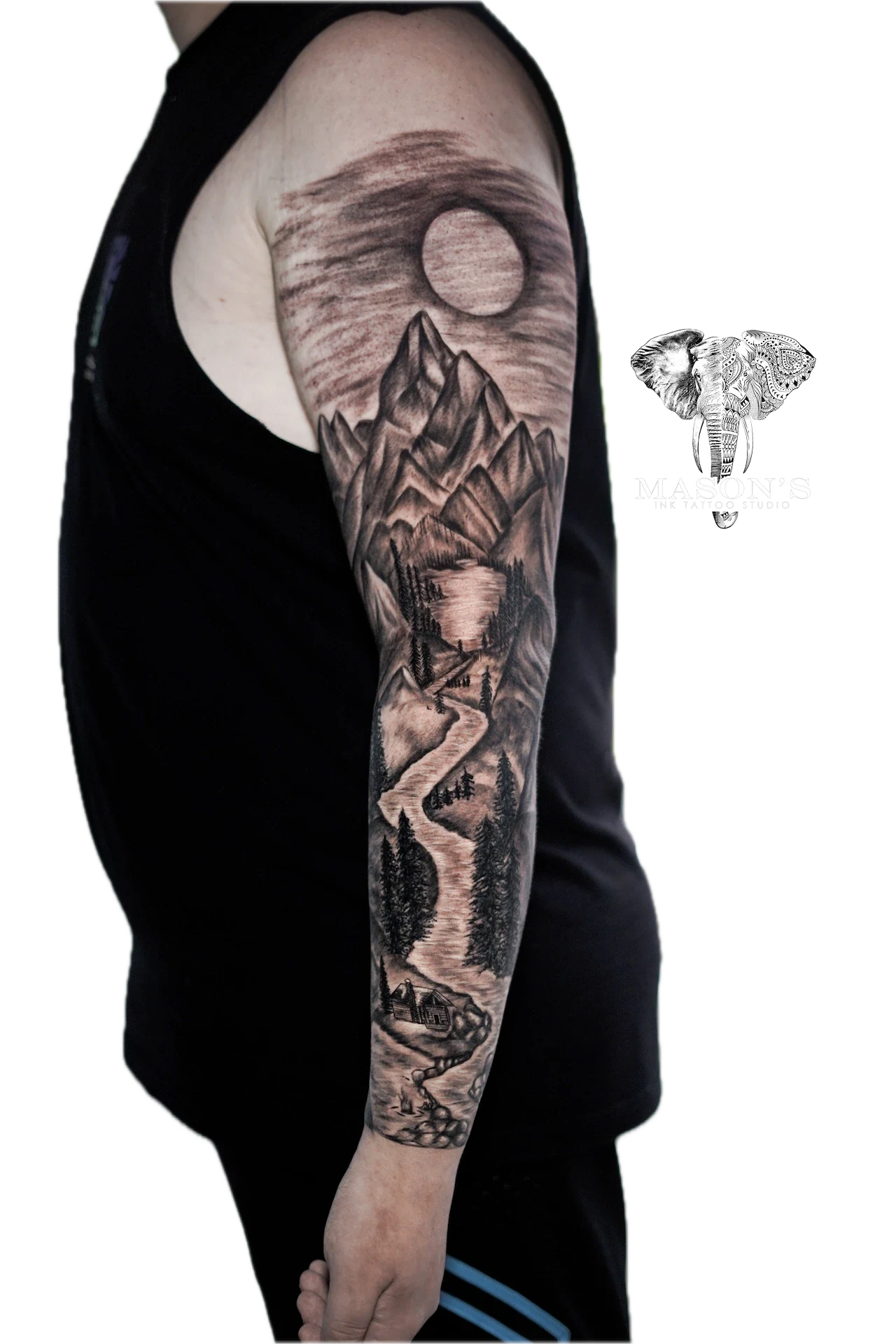 Black and Grey Realism Tattoo Style: a detailed black and grey mountain landscape sleeve tattoo