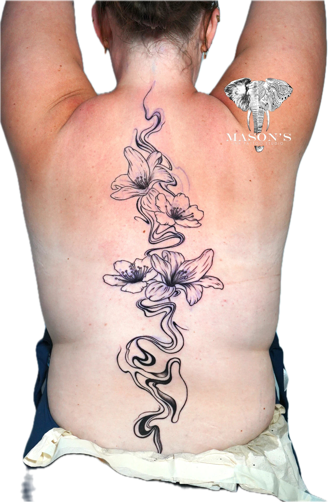 Blackwork Tattoo Design: a large floral vine with an elephant and lettering on the back