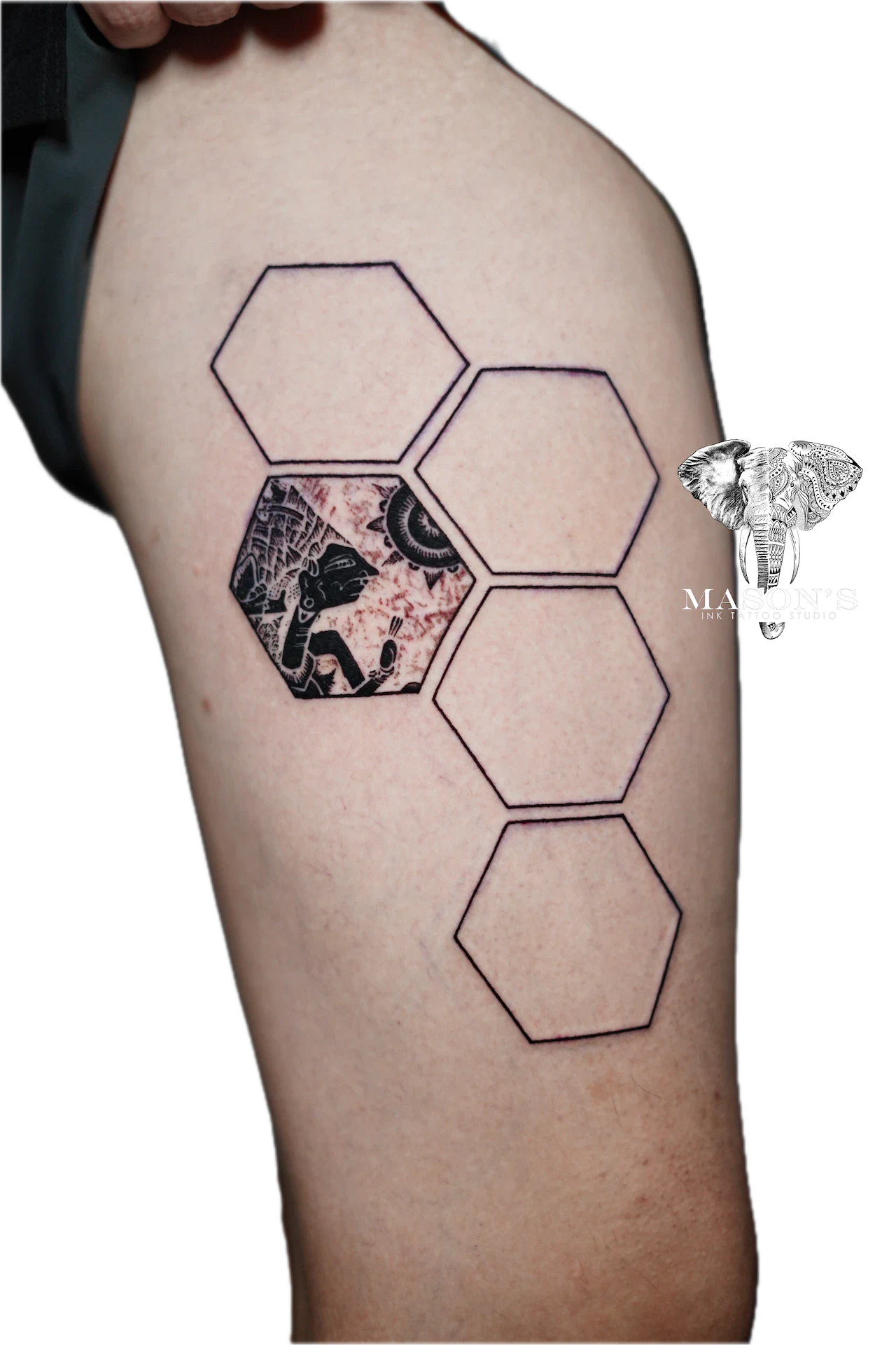 Blackwork Wayang and Sun Tattoo Design: a geometric pattern with a cityscape and skull on an upper arm