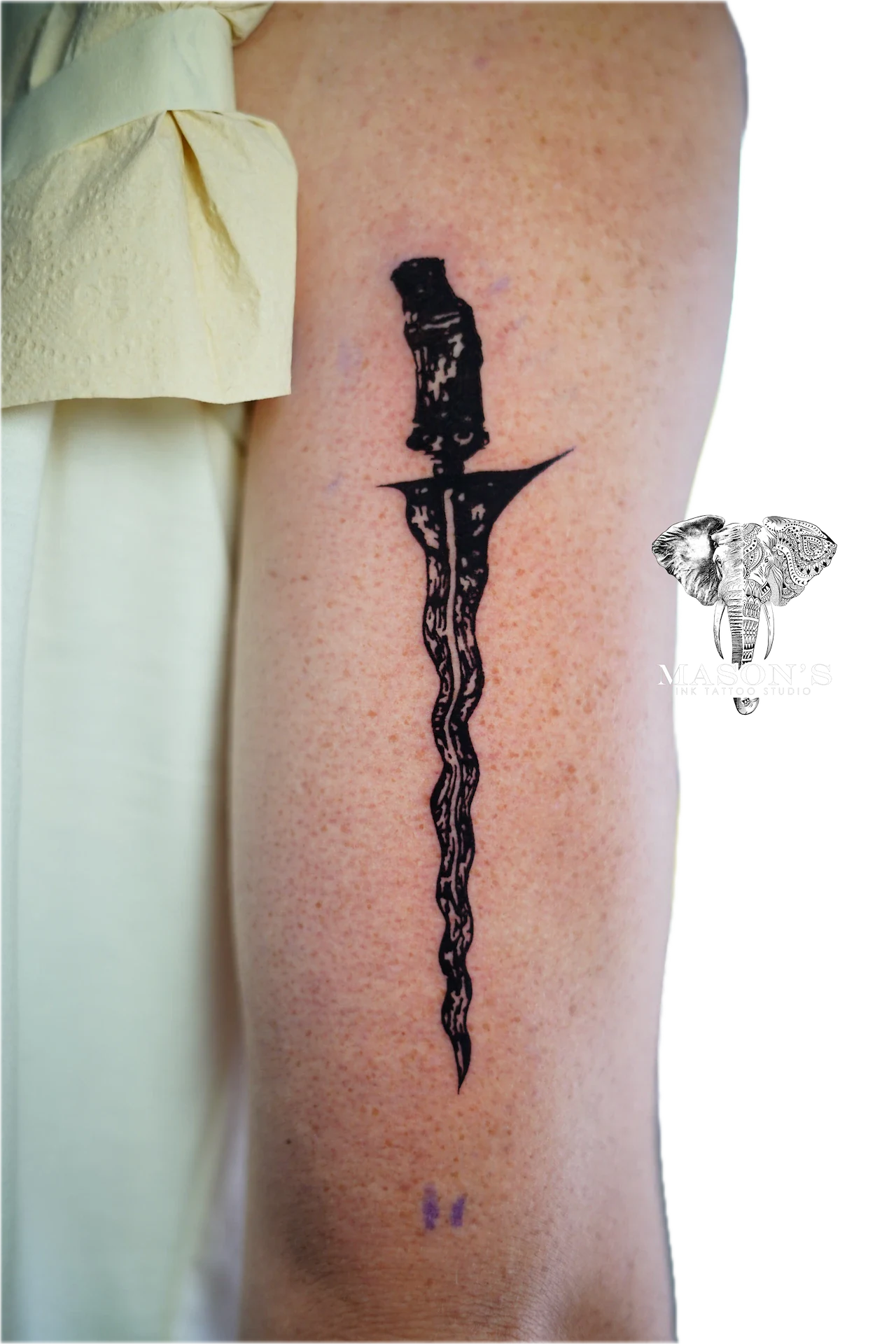 Traditional Blackwork Keris Tattoo Design: a twisted sword tattoo on the thigh