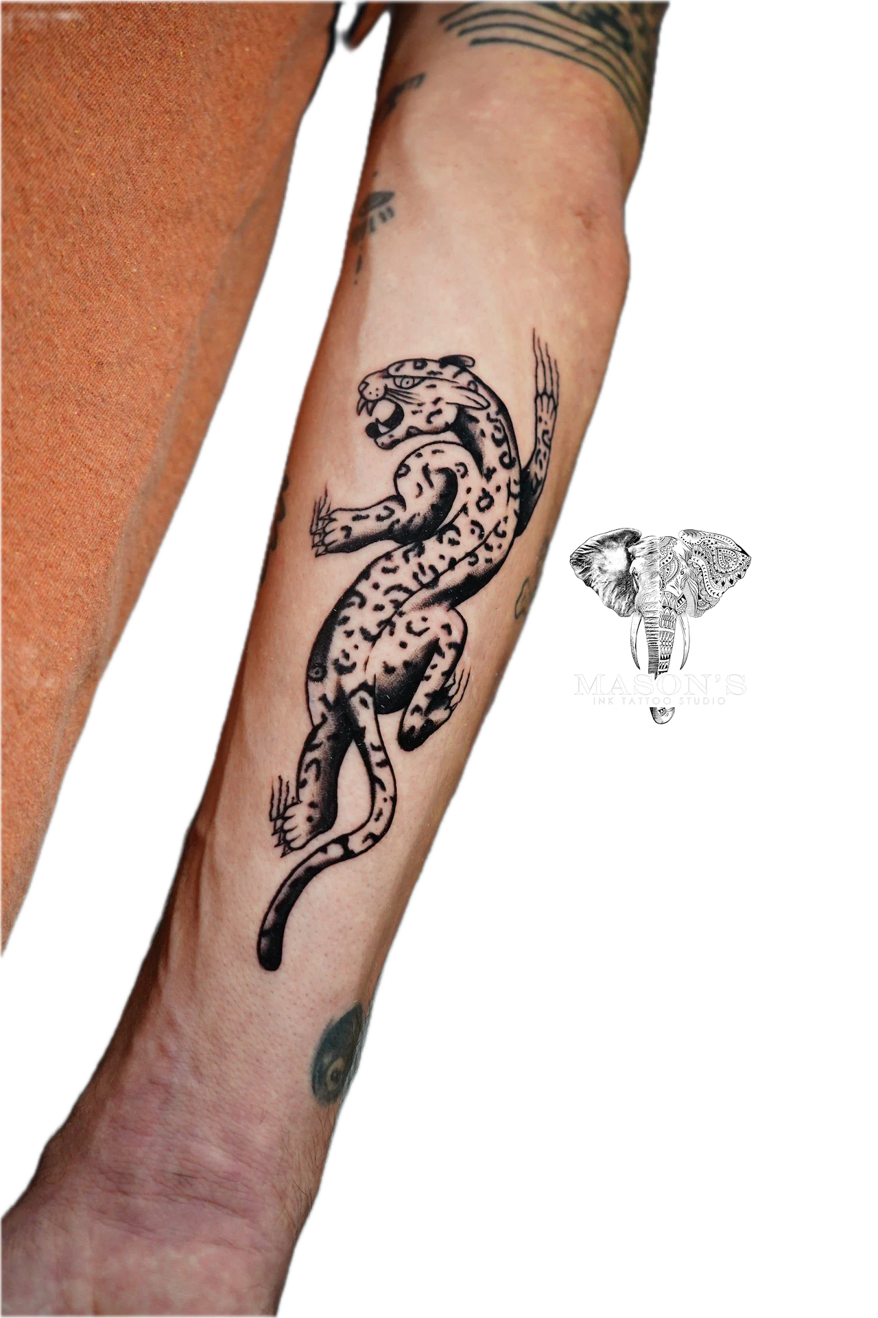 Traditional Black Work Jaguar Tattoo Design: a leopard climbing up a forearm in black and grey