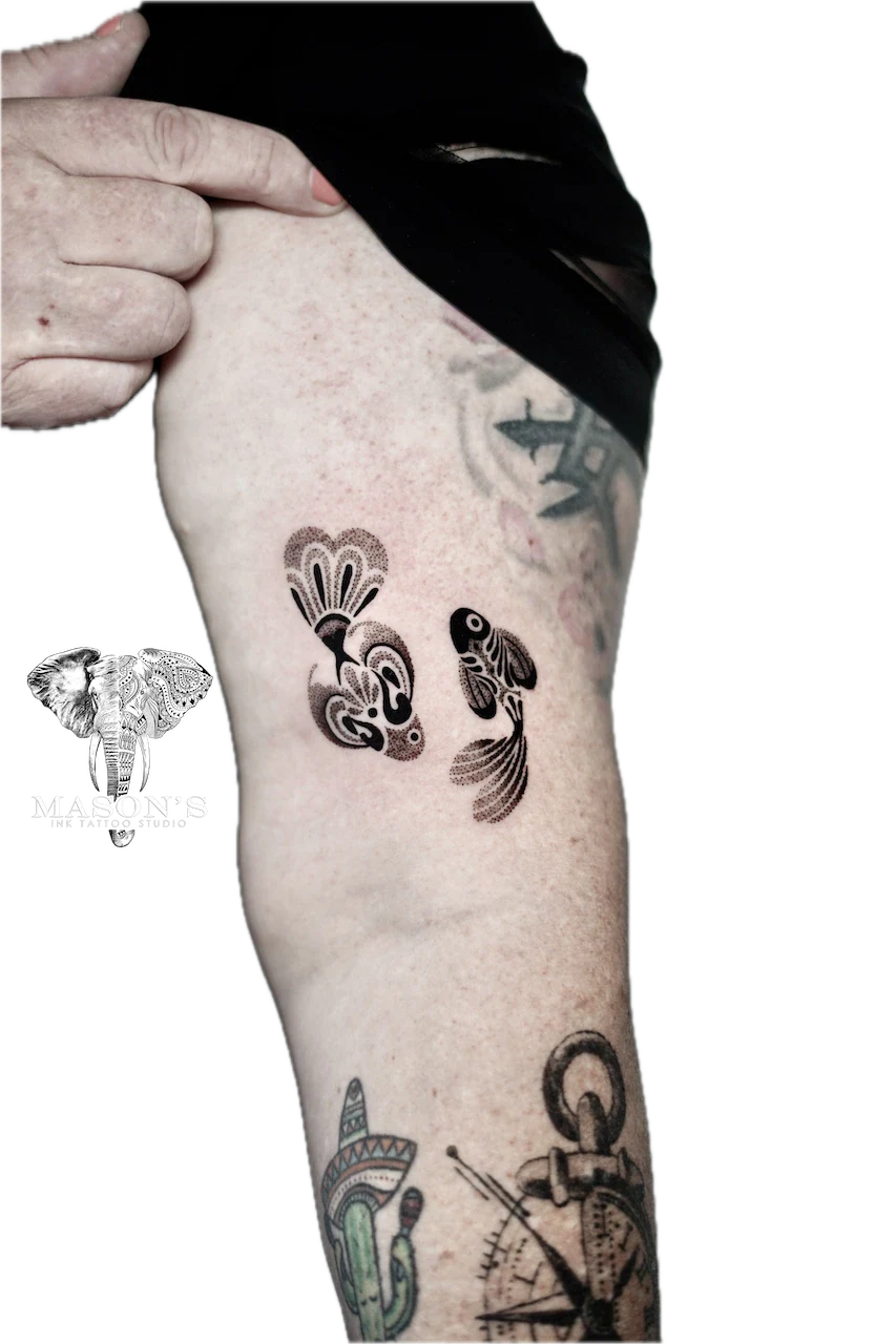 Blackwork Ornamental Fish Tattoo Design: Two koi fish with floral designs on a forearm