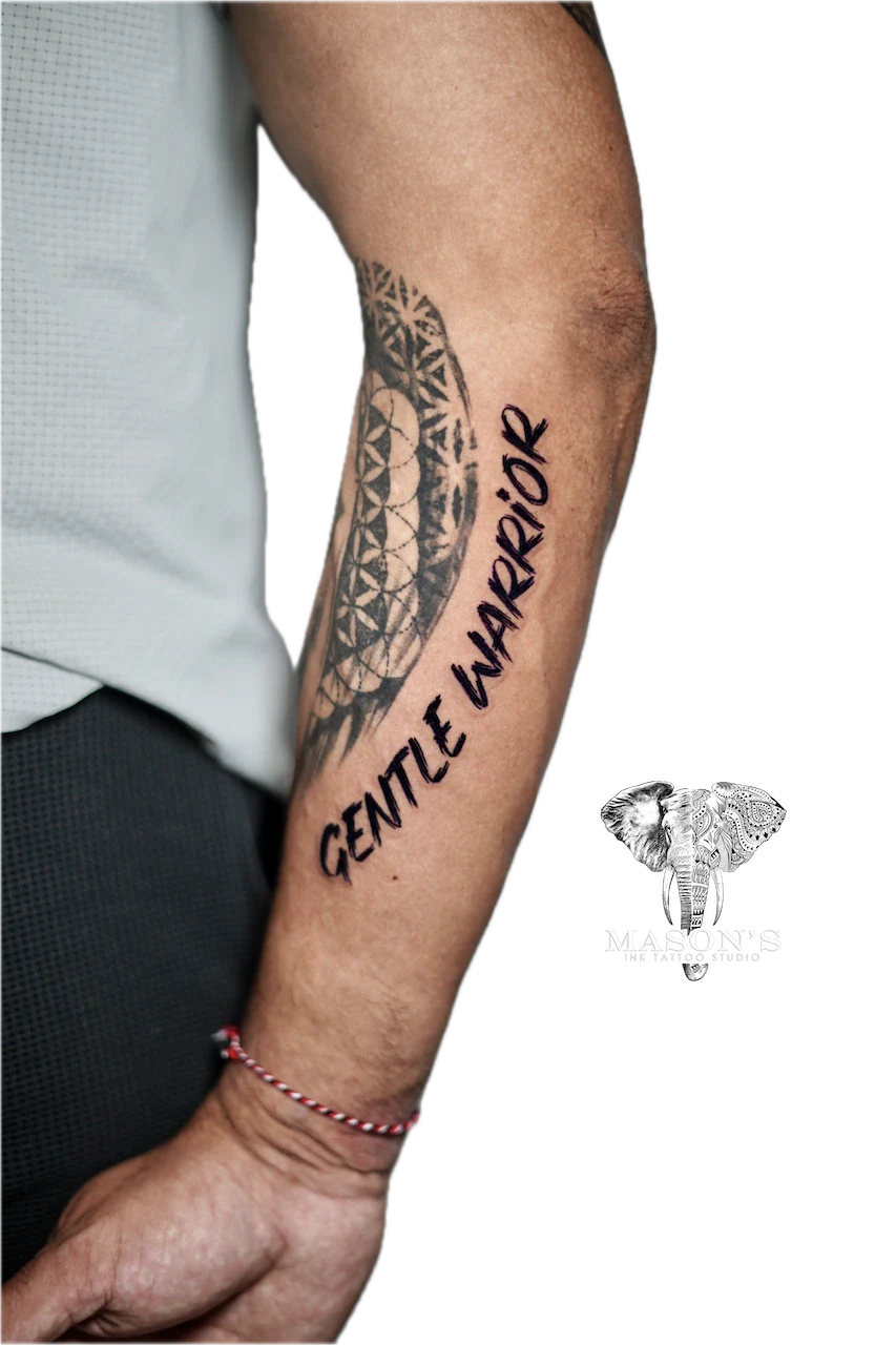 Blackwork Script Tattoo Design: a large forearm tattoo with geometric patterns and the words 'gentle warrior'